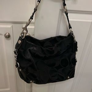 2010 Coach signature shoulder bag. Black on black initial with silver hardware.